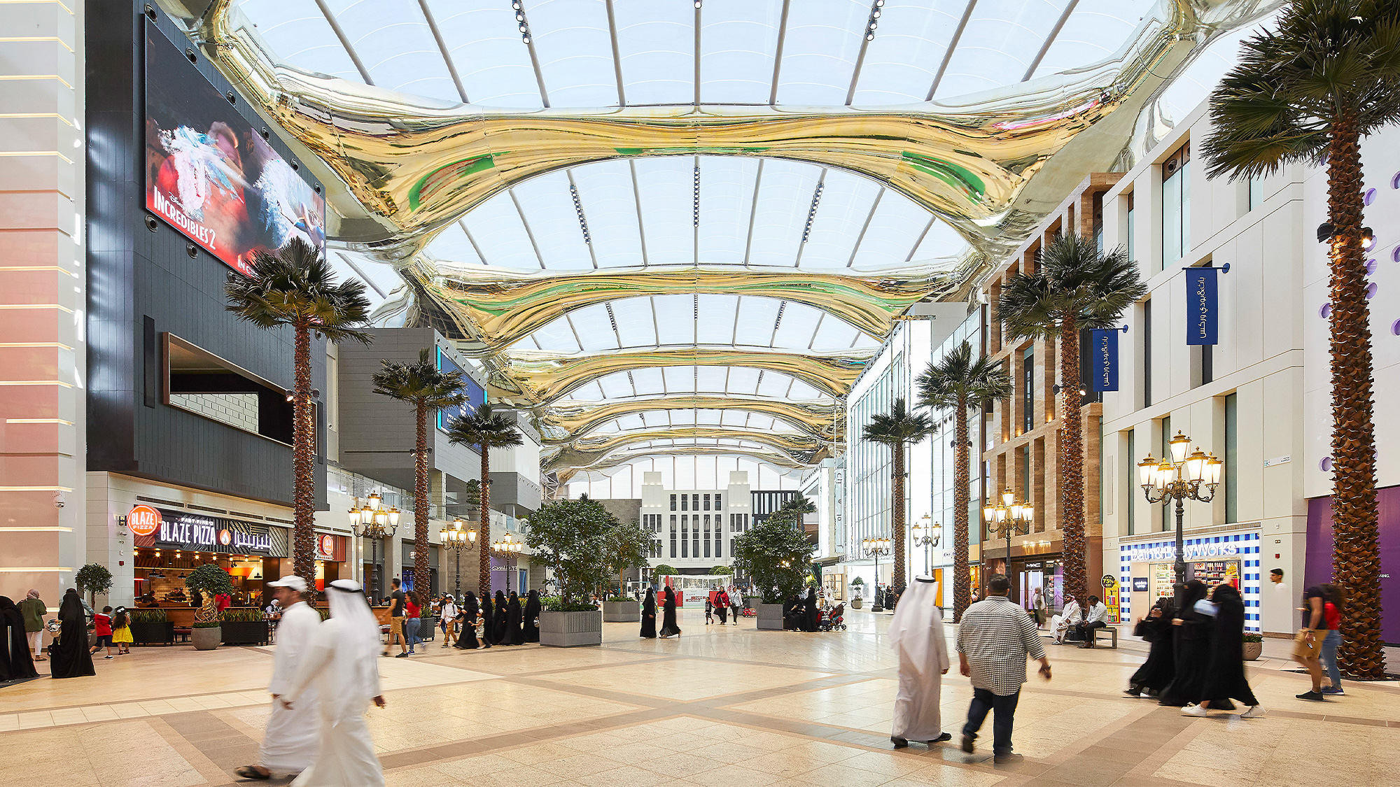A large shopping mall with people walking around.