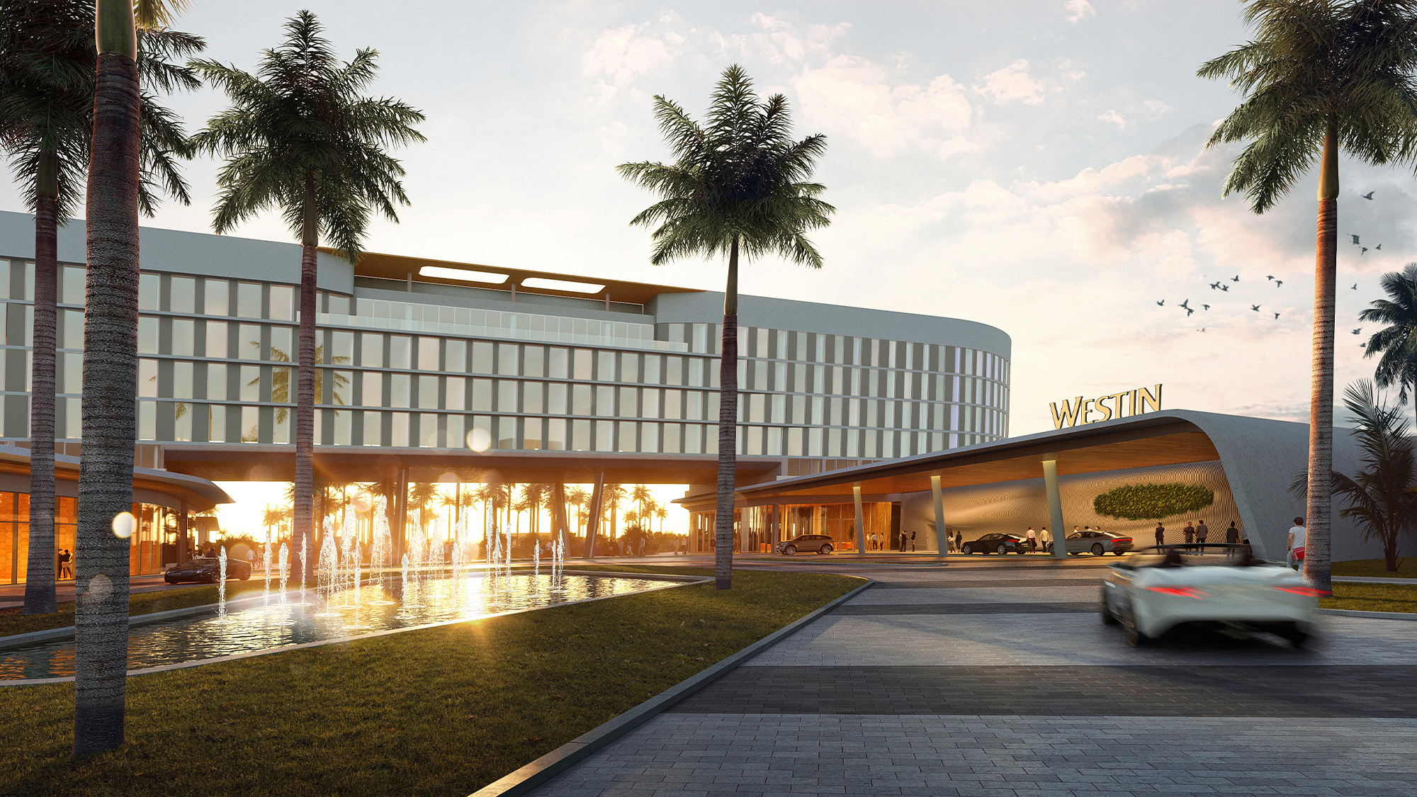 A building with palm trees and a road.