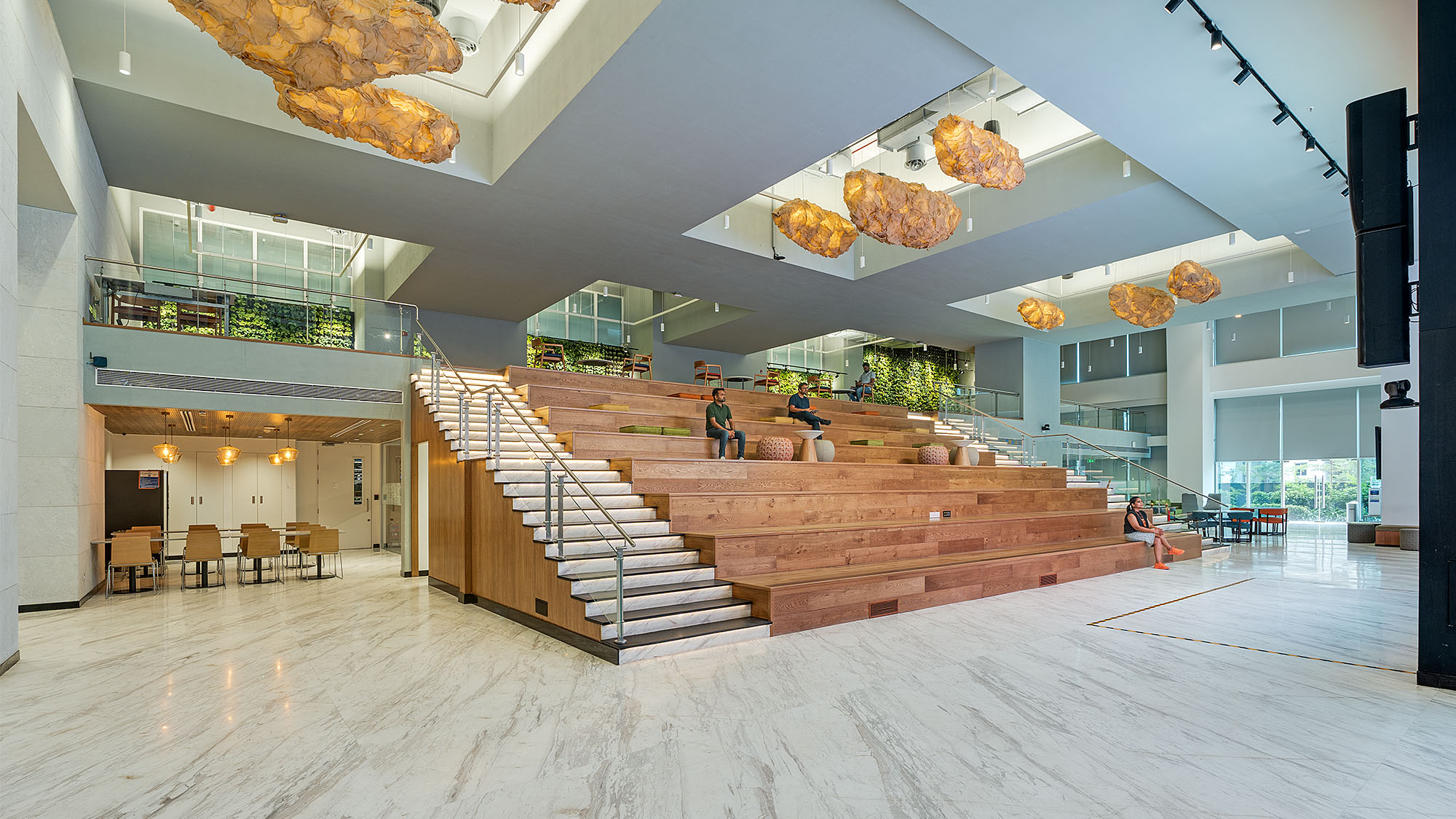 A large room with a staircase and tables.