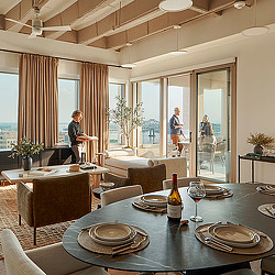 A dining room with a table and chairs.
