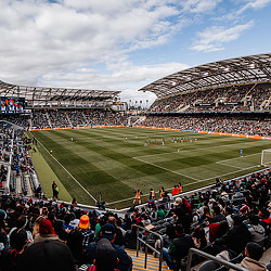 A sports stadium with a field and a crowd of people.
